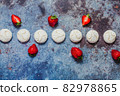 strawberries and marshmallows on a blue metal background. Healthy lifestyle and summer diet detox food concept. Copy space for text 82978865