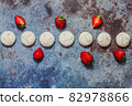 strawberries and marshmallows on a blue metal background. Healthy lifestyle and summer diet detox food concept. Copy space for text 82978866