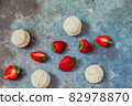 strawberries and marshmallows on a blue metal background. Healthy lifestyle and summer diet detox food concept. Copy space for text 82978870