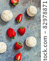 strawberries and marshmallows on a blue metal background. Healthy lifestyle and summer diet detox food concept. Copy space for text 82978871