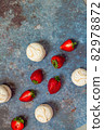 strawberries and marshmallows on a blue metal background. Healthy lifestyle and summer diet detox food concept. Copy space for text 82978872
