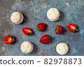 strawberries and marshmallows on a blue metal background. Healthy lifestyle and summer diet detox food concept. Copy space for text 82978873