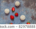 White marshmallows and strawberries with coffee on a blue metal background. Free space for text.Top view.Holiday and festive food concept 82978888