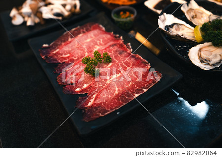 Sliced beef shabu in a black plate in a restaurant 82982064