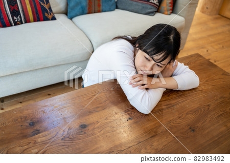 Woman lying down in the living room Woman lying down in the living room 82983492