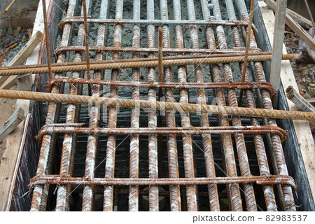 SELANGOR, MALAYSIA -MAY 18, 2016: Hot rolled deformed steel bars or steel reinforcement bar tied together before cast in the concrete. Its function is to increase the concrete strength. SELANGOR, MALAYSIA -MAY 18, 2016: Hot rolled deformed steel bars or steel reinforcement bar tied together before cast in the concrete. Its function is to increase the concrete strength. 82983537