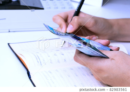 Tenge in the hands of an accountant cashier at a company in Kazakhstan. Tenge in the hands of an accountant cashier at a company in Kazakhstan. 82983561