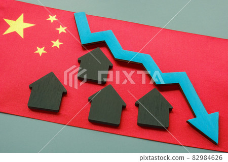 Chinese flag and houses on it. China developers debt crisis. 82984626
