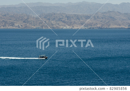 Two pleasure boats sail in the Red Sea during the day near the coast of Eilat in Israel the coast of Jordan is visible in the background Two pleasure boats sail in the Red Sea during the day near the coast of Eilat in Israel the coast of Jordan is visible in the background 82985856