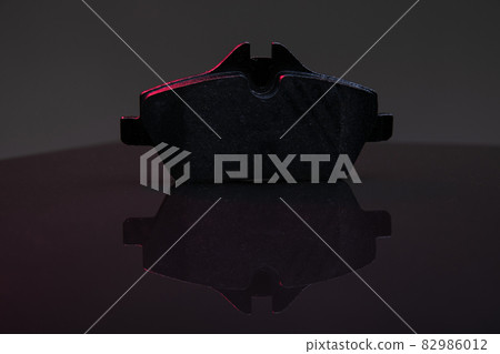 traffic safety, car brake system component, brake pad on dark background traffic safety, car brake system component, brake pad on dark background 82986012