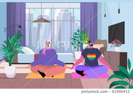 gay practicing yoga exercise in lotus pose LGBT parade pride festival transgender love concept living room interior 82986452