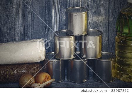 canned food and various cereals on a wooden shelf, food crisis canned food and various cereals on a wooden shelf, food crisis 82987852