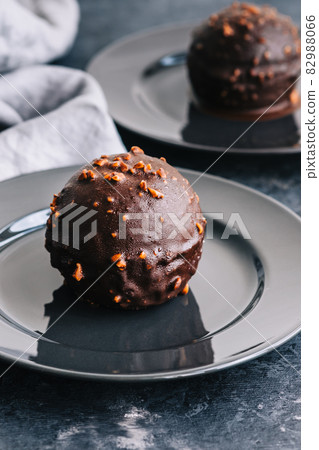 Chocolate dessert with cream, nuts and biscuit on plate. Chocolate dessert with cream, nuts and biscuit on plate. 82988066
