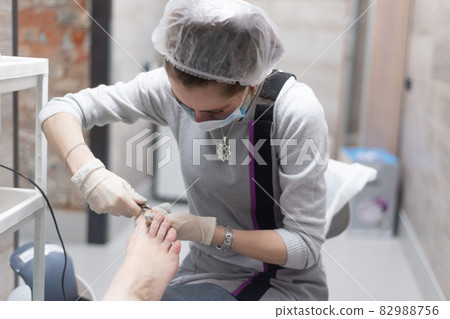 Manicurist and nail extension in the office, salon 82988756
