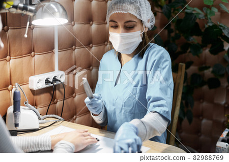 Manicurist and nail extension in the office, salon Manicurist and nail extension in the office, salon 82988769