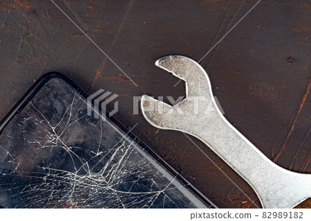 Mobile smartphone with broken screen close up Mobile smartphone with broken screen close up 82989182