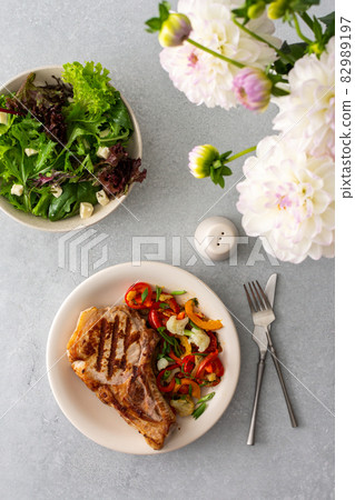 Pork entrecote on the bone with salad Pork entrecote on the bone with salad 82989197