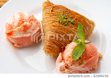 Close up photo of Turkish baklava served with ice cream Close up photo of Turkish baklava served with ice cream 82989230