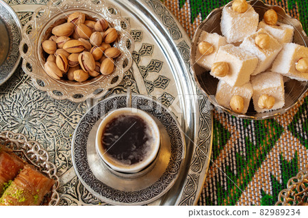 Traditional arabic dessert baklava with a cup of turkish coffee Traditional arabic dessert baklava with a cup of turkish coffee 82989234