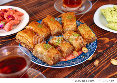 Turkish sweet baklava with Turkish tea on wooden background Turkish sweet baklava with Turkish tea on wooden background 82989236
