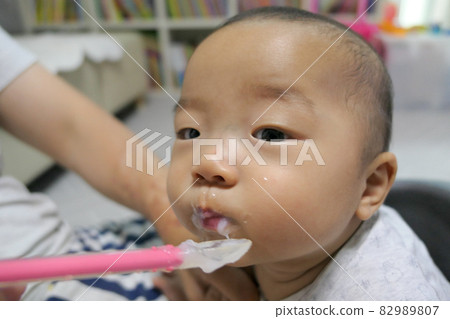 cute baby eating baby food cute baby eating baby food 82989807