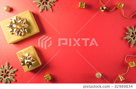 Online shopping of China, 11.11 singles day sale concept. Top view of golden christmas gift boxes with ribbon on red background with copy space. 82989834