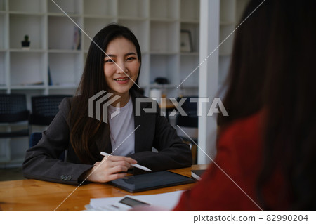 During a job interview, Woman in a suit and gives a presentation about herself During a job interview, Woman in a suit and gives a presentation about herself 82990204