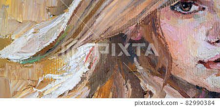 .A woman in a straw hat sits in the sunset. 82990384