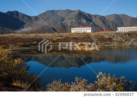 A majestic autumn view of the Arctic village, located on the lake in a mountain valley. A majestic autumn view of the Arctic village, located on the lake in a mountain valley. 82990837