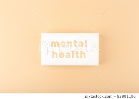 Mental health text written on white tablet on bright beige background Mental health text written on white tablet on bright beige background 82991196