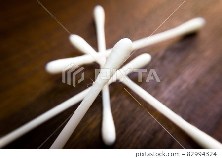 Table of cotton swabs and brown wood grain 82994324