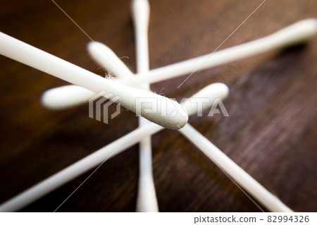 Table of cotton swabs and brown wood grain Table of cotton swabs and brown wood grain 82994326