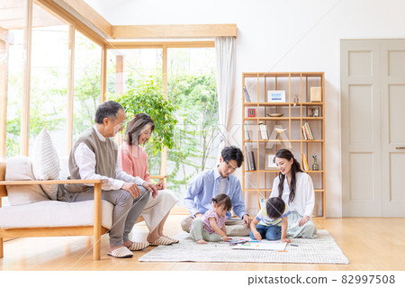 Three-generation family relaxing in the living room Three-generation family relaxing in the living room 82997508