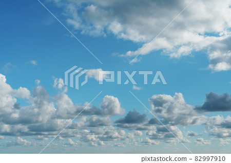 Blue sky with cumulus clouds over the sea Blue sky with cumulus clouds over the sea 82997910