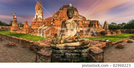 Ruins of buddha statue and pagoda on colorful background, Scenic view of Thai historical buddha statue and pagoda at dusk, Buddha statue and ruins of a pagoda at Ayutthaya historical park Ruins of buddha statue and pagoda on colorful background, Scenic view of Thai historical buddha statue and pagoda at dusk, Buddha statue and ruins of a pagoda at Ayutthaya historical park 82998223