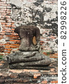 Ruins of the ancient temple and the bas-relief of buddha on blue sky, Scenic view of Thai historical buddha statue at dusk, Low angle view of ancient buddha statue at Thailand historical site 82998226