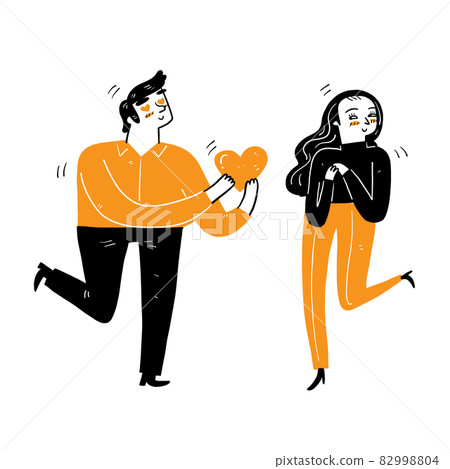 A young man gives a big heart to a young woman A young man gives a big heart to a young woman 82998804