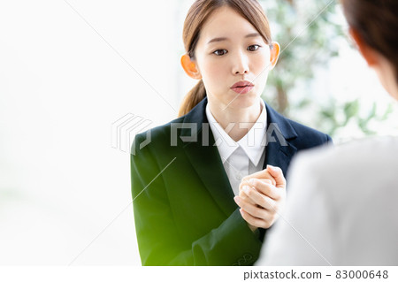 A young woman talking to a person facing her A young woman talking to a person facing her 83000648