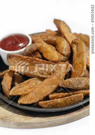spicy curry powder coated crispy deep fried potato wedges spicy curry powder coated crispy deep fried potato wedges 83001682