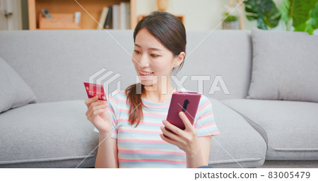 woman online shopping with credit 83005479