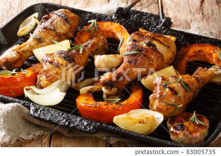 Healthy BBQ food grilled chicken legs with seasonal vegetables close-up in a grill pan. horizontal Healthy BBQ food grilled chicken legs with seasonal vegetables close-up in a grill pan. horizontal 83005735