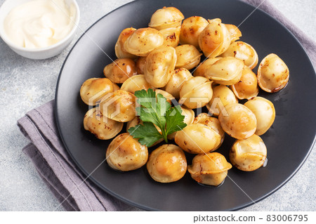 Traditional fried pelmeni, ravioli, dumplings filled with meat on black plate, russian kitchen. Gray concrete background, copy space. Traditional fried pelmeni, ravioli, dumplings filled with meat on black plate, russian kitchen. Gray concrete background, copy space. 83006795