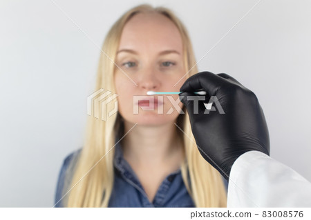 The girl complains to the doctor about the loss of smell. The doctor conducts a sense of smell test. Diagnostics of covid-19. Symptoms of the coronavirus. Quarantine and isolation. Test for sars-cov-2 The girl complains to the doctor about the loss of smell. The doctor conducts a sense of smell test. Diagnostics of covid-19. Symptoms of the coronavirus. Quarantine and isolation. Test for sars-cov-2 83008576