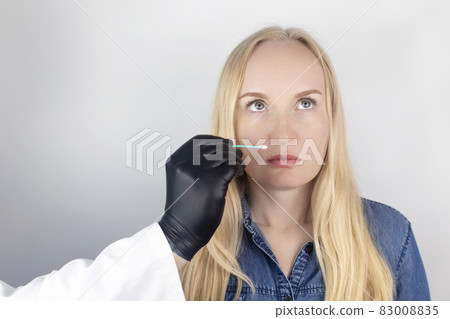 The girl complains to the doctor about the loss of smell. The doctor conducts a sense of smell test. Diagnostics of covid-19. Symptoms of the coronavirus. Quarantine and isolation. Test for sars-cov-2 The girl complains to the doctor about the loss of smell. The doctor conducts a sense of smell test. Diagnostics of covid-19. Symptoms of the coronavirus. Quarantine and isolation. Test for sars-cov-2 83008835