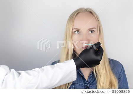 The girl complains to the doctor about the loss of smell. The doctor conducts a sense of smell test. Diagnostics of covid-19. Symptoms of the coronavirus. Quarantine and isolation. Test for sars-cov-2 83008836