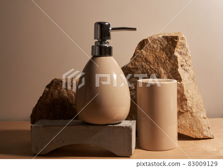 Beige bottle for cosmetics on a beige background, on the podium with a place for your product. High quality photo Beige bottle for cosmetics on a beige background, on the podium with a place for your product. High quality photo 83009129