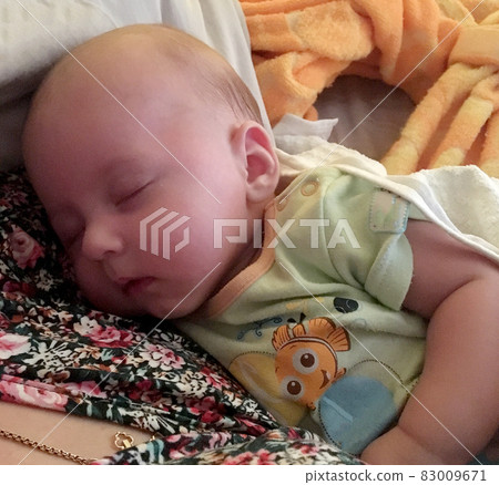 Sleeping baby boy with child clothes posing photographer for color photo Sleeping baby boy with child clothes posing photographer for color photo 83009671