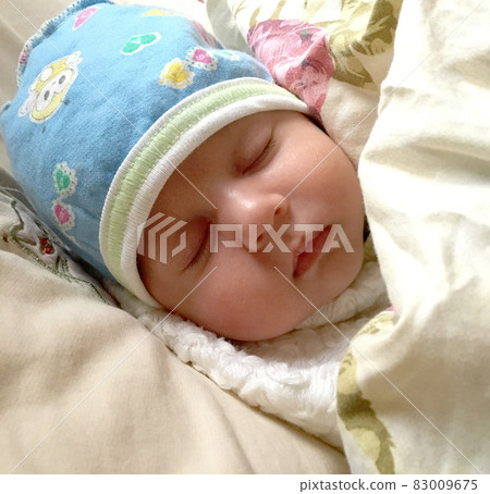 Beautiful sleeping baby boy with child hat posing photographer for color photo Beautiful sleeping baby boy with child hat posing photographer for color photo 83009675