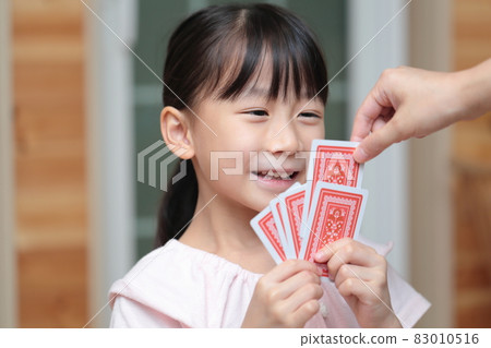 Girl playing cards to maid 83010516