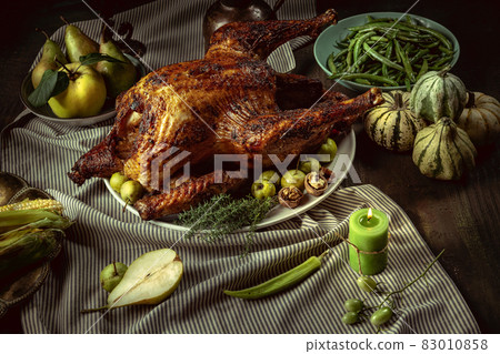 Greeting card design with roasted turkey, chicken and autumn traditional vegetables. Figs, pumpkins. Thanksgiving day Greeting card design with roasted turkey, chicken and autumn traditional vegetables. Figs, pumpkins. Thanksgiving day 83010858